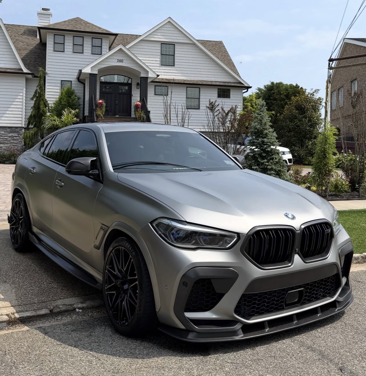 Silver performance SUV after detailing in a driveway