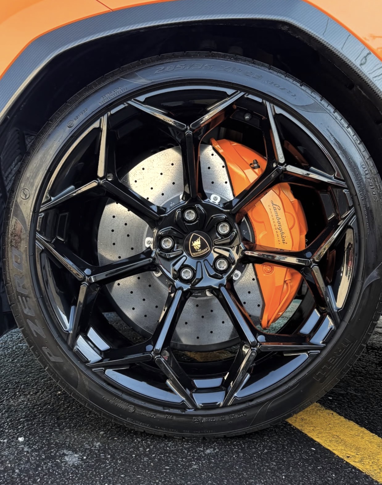 Close-up of a clean black wheel and orange brake caliper